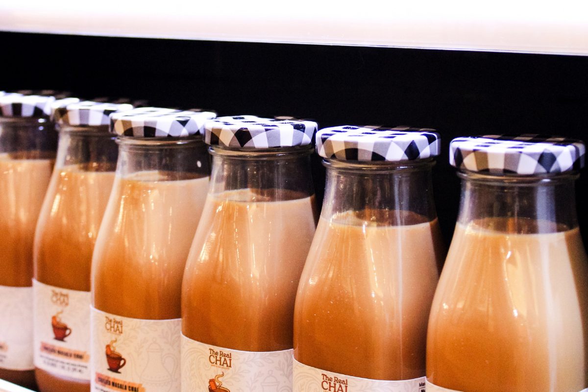 Bottled masala chai from The Real Chai lined up on a shelf